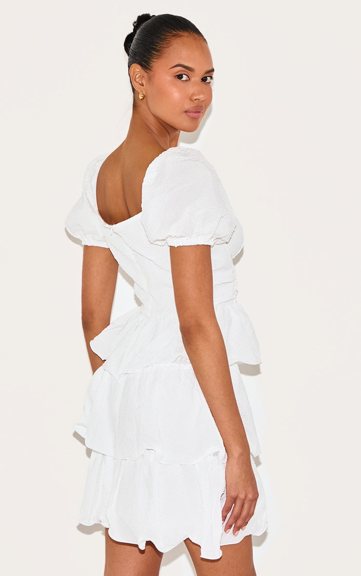 https://cdn-img.prettylittlething.com/0/2/a/5/02a5c99aadc9657cee3f17363ede3b5253a02b24_CMT1587_2_white_crinkle_cup_detail_tiered_skirt_skater_dress.jpg