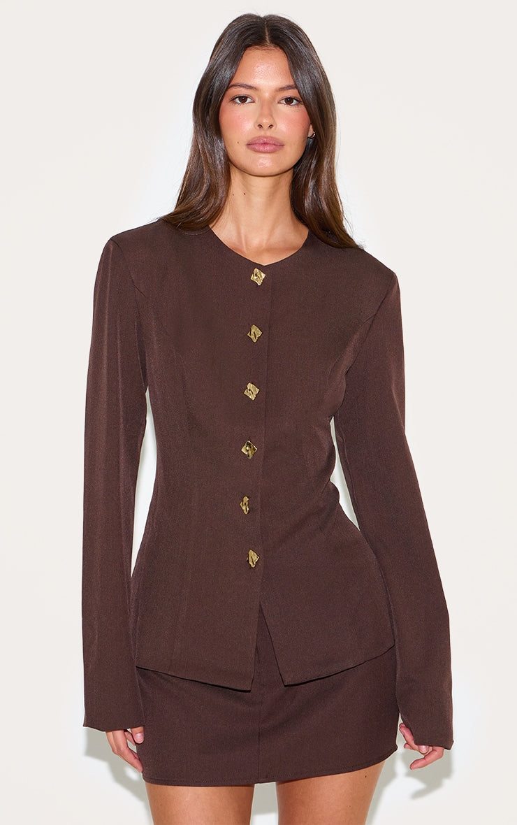 https://cdn-img.prettylittlething.com/1/2/d/2/12d2b870ea611fc3b127492dc899fb4e2e157e32_CNM0404_1_deep_chocolate_gold_trim_cinched_waist_shirt.jpg